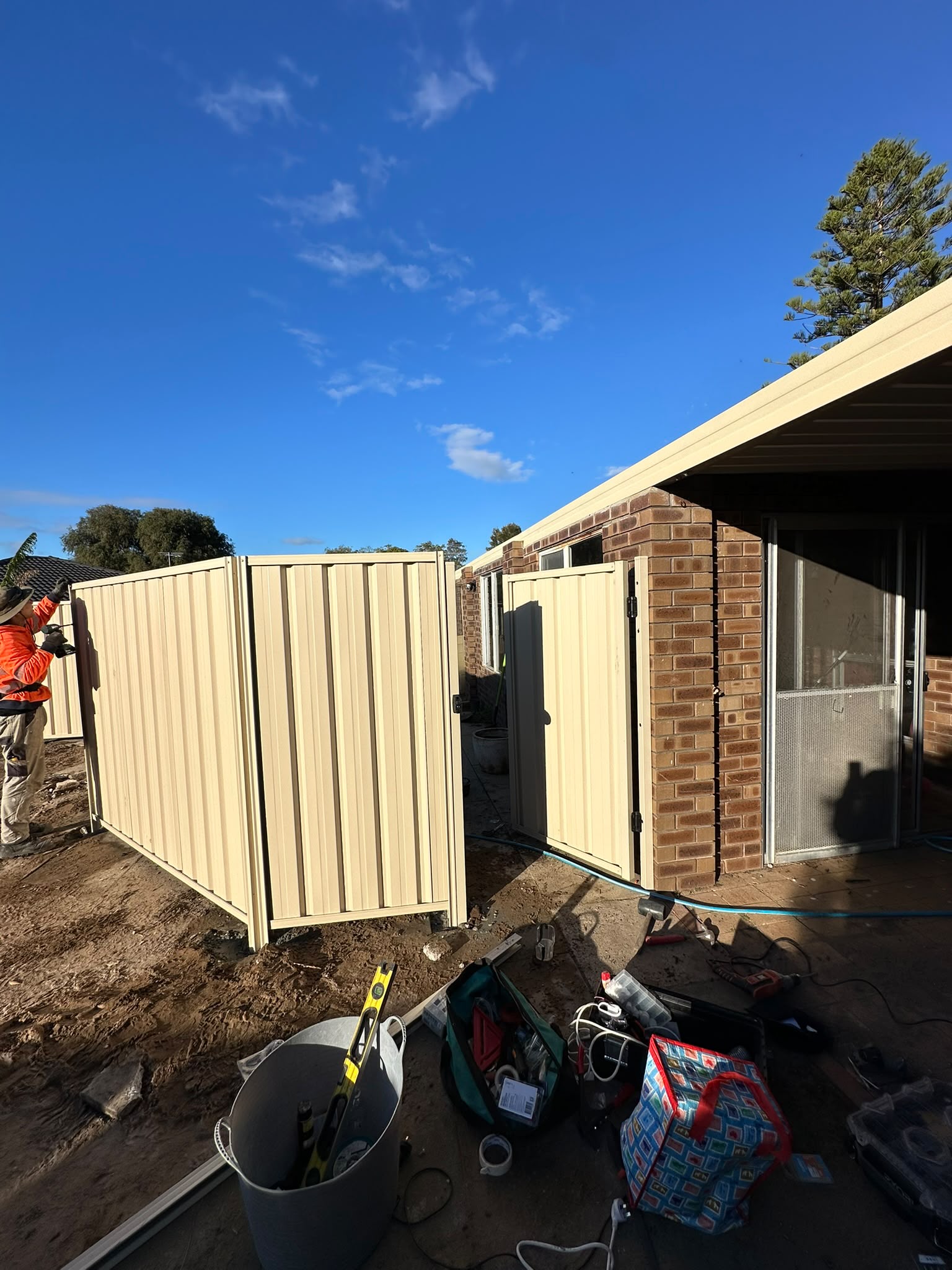 Cream Colorbond gates and fencing during installation