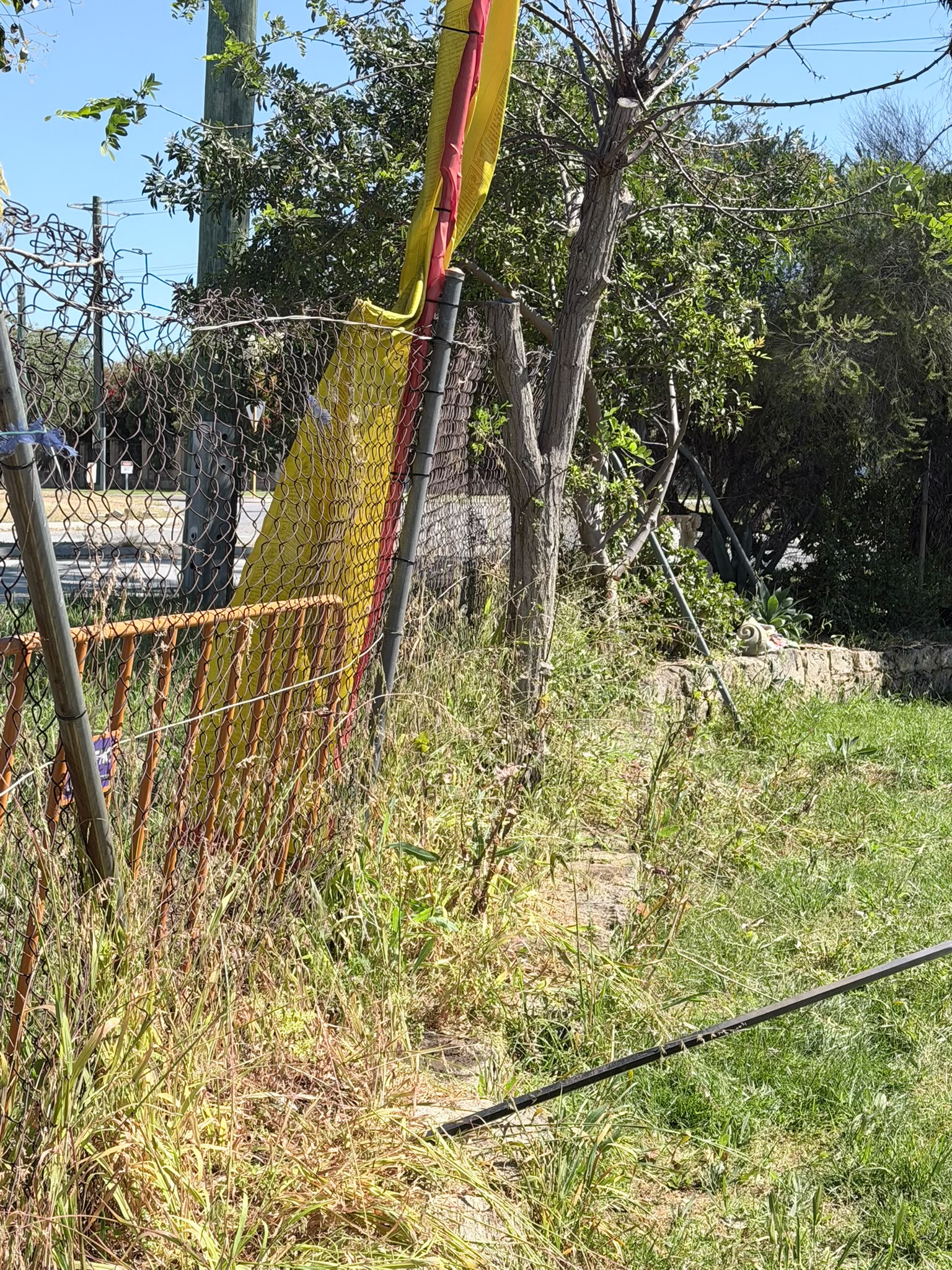 Old chain-link boundary fence before replacement at the Wanneroo project